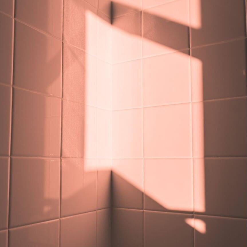 Picture of a pink tiled restroom wall